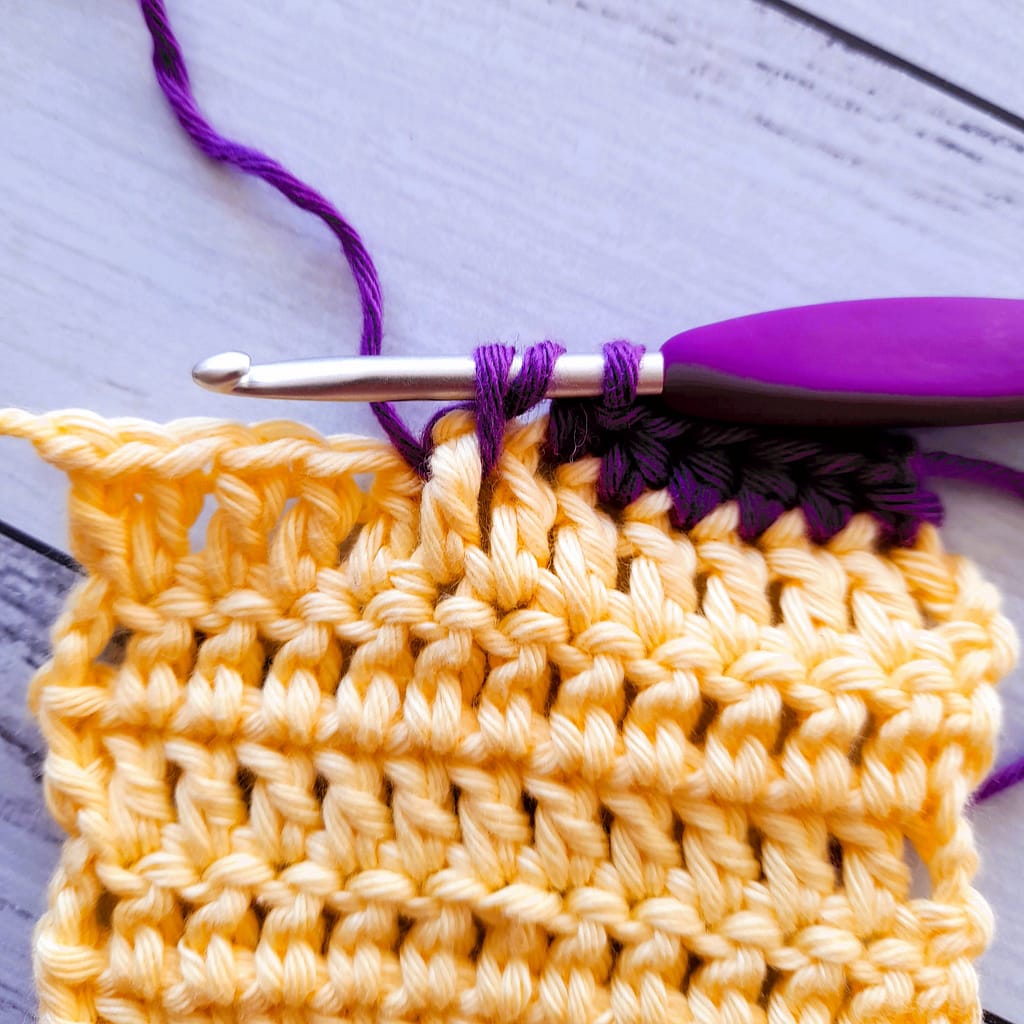 second step of a front post half double crochet stitch