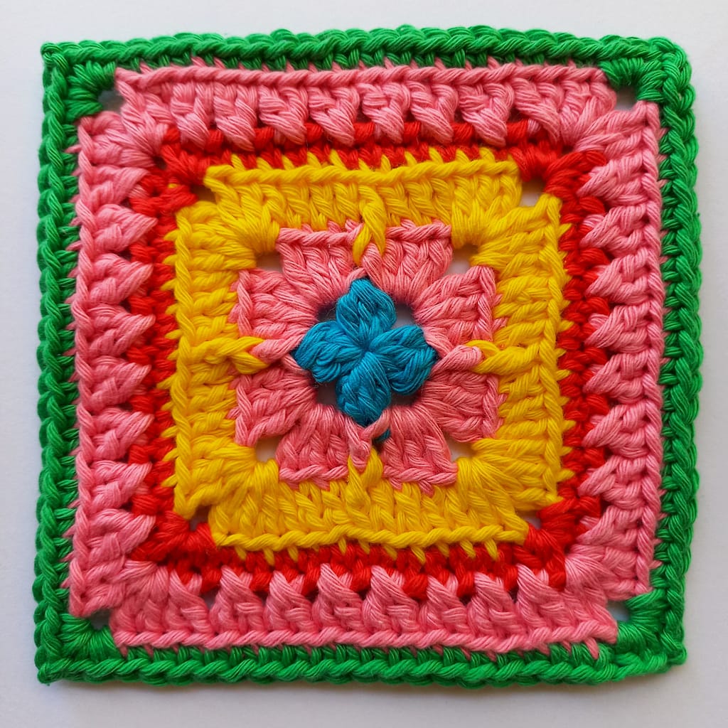 A colourfuland testured crochet granny square that showcases raised and twisted stitches