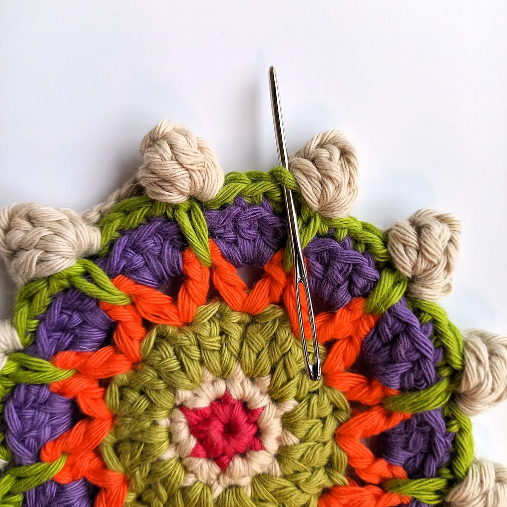 needle indicates placement of first stitch in round 8