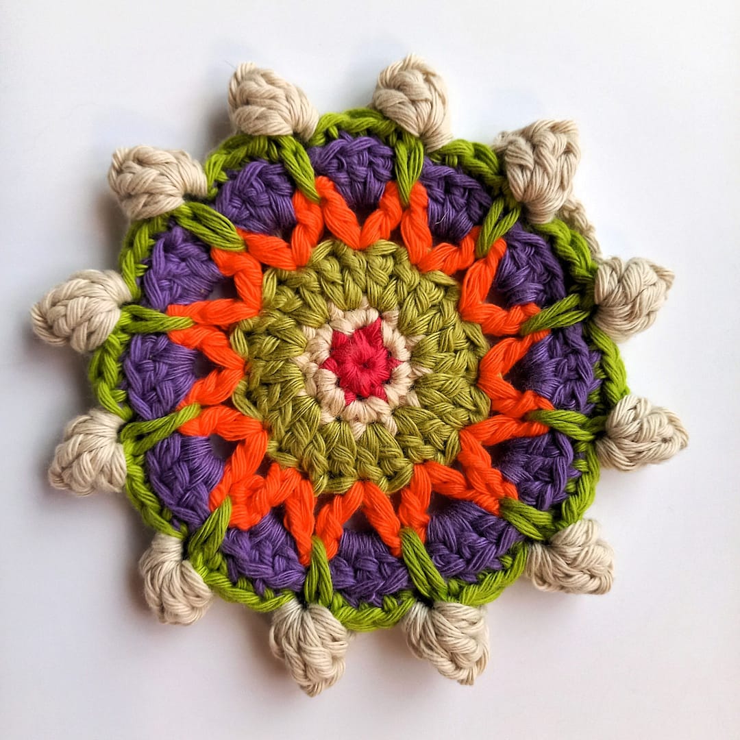 popcorn stitches made into single crochet spikes in the mandala