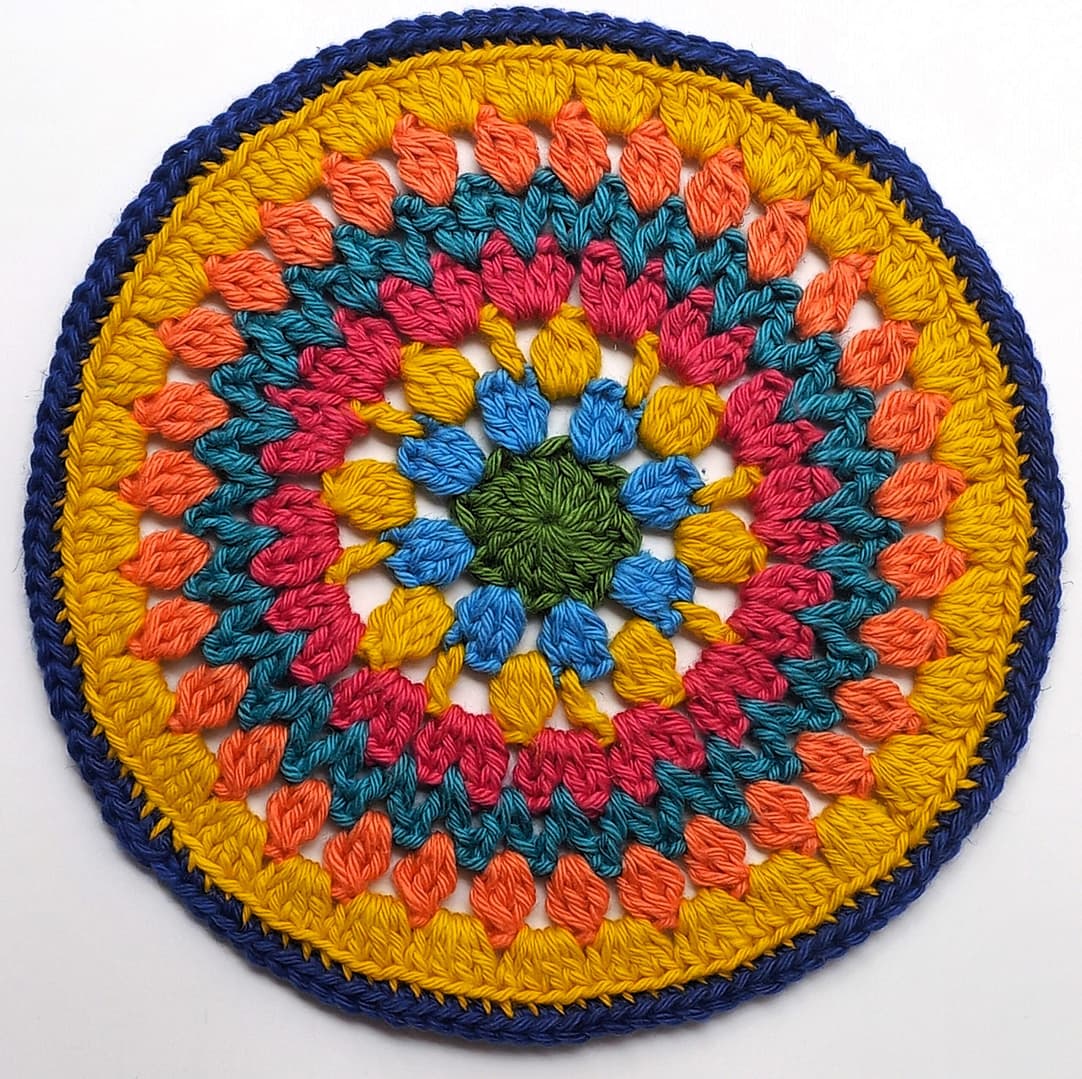 completed crochet mandala in severn colours