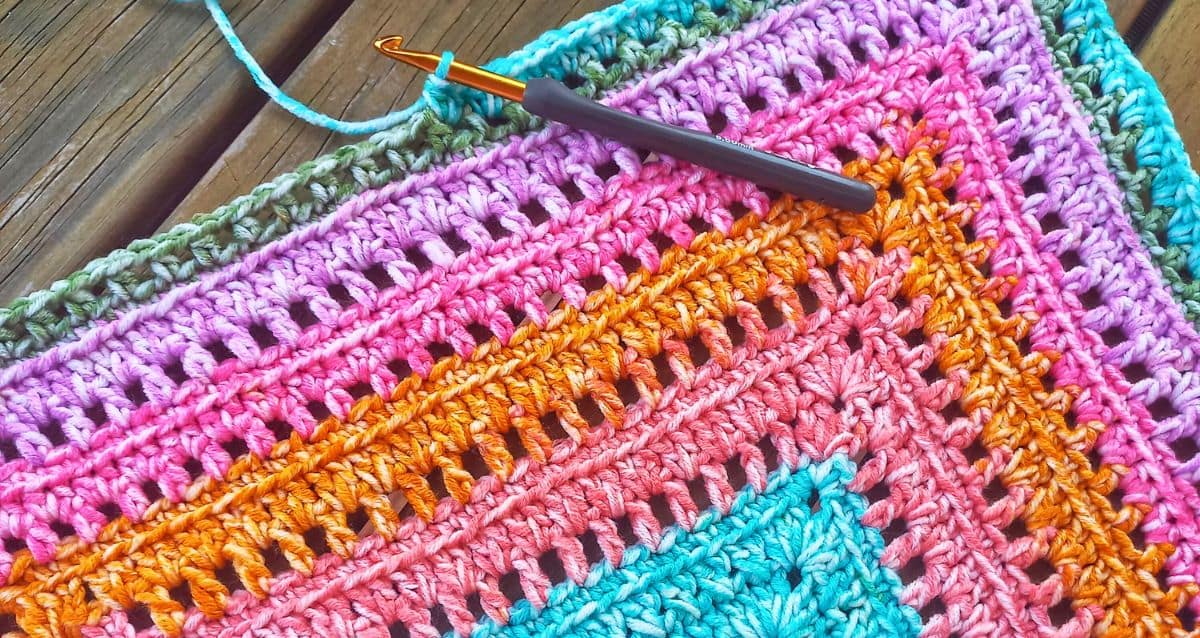 one of the benefits of crocheting for caregivers is the mental peace and clarity that come from patterns like this one - the image shows round after round of repetitive stitches in bright colours