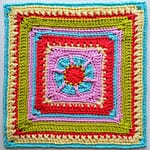 flat lay of the granny square close up in red, cream, turquoise, green and pink yarns